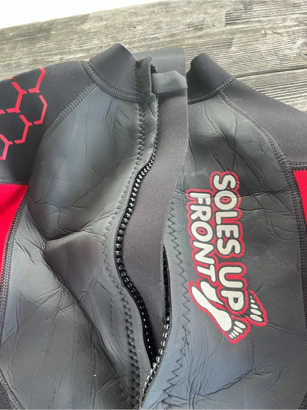 Kids Black and Red Wetsuit -soles up front 10/12 approx